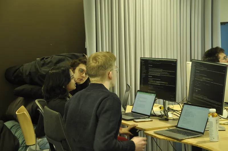 Photo of people looking at monitor doing research