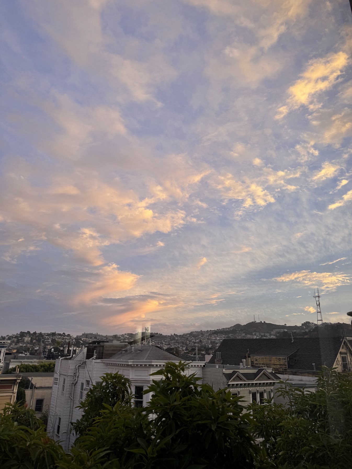 Sunset over rooftops from the Lower Haight apartment